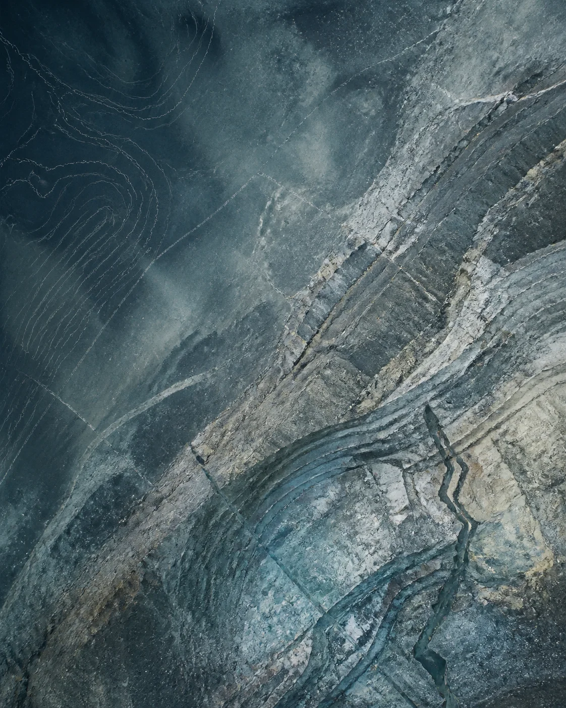 Abstract blue-gray mineral terrain with geological contour traces